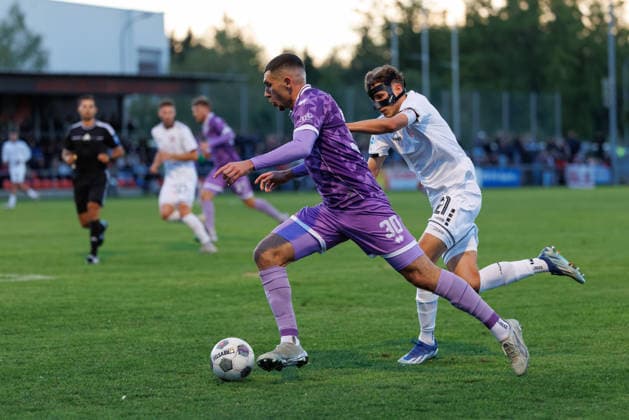 Ognjen Drakulic, 30, FC Ingolstadt 04 in the background; Kilian Pittrich, 21, TSV Landsberg, during the match between TSV Landsberg and FC Ingolstadt 04, soccer, men s, Toto Cup, 2026–2027, quarterfinals on September 23, 2026, in Landsberg am Lech, Sportpark Bayern, Germany