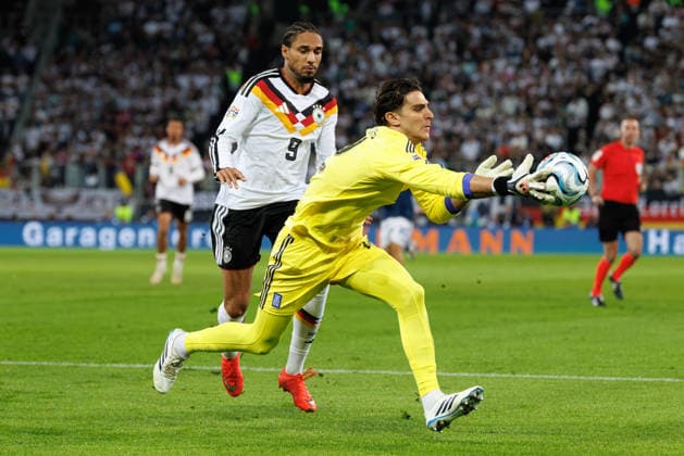 Kostas Tzolakis 12, Greece, ahead of Kevin Schade 9, Germany, in the match between Germany and Greece, men s soccer, UEFA Nations League, 2026–2027, Matchday 2 on September 27, 2026, in Augsburg, WWK Arena, Bavaria, Germany
