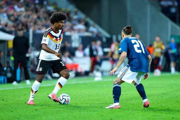 September 27, 2026, GER, Soccer, Men s, UEFA Nations League, League A, 2026–2027 Season, Matchday 2, Germany vs. Greece: Karim Adeyemi (Germany, No. 19) on the left, Kostas Tsimikas (Greece, No. 21) on the right. DFB and DFL regulations prohibit any use of photographs as image sequences and or quasi-video. Augsburg WWK Arena, Bavaria, Germany Copyright: xNordphoto Schneiderx