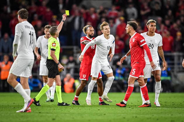 RECORD DATE NOT STATED 1st October 2026; Cardiff City Stadium, Cardiff, Wales; UEFA Nations League Football, Wales versus Norway; Referee Alejandro Hernandez (ESP) issues a yellow card to Martin Odegaard of Norway as he gets a push in the back from Sorba Thomas of Wales GodfreyxPitt