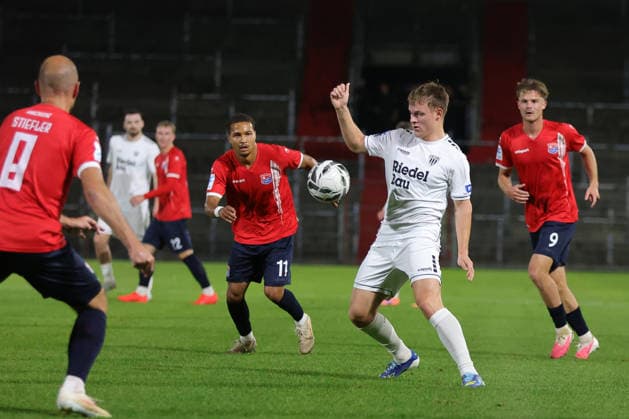 October 2, 2026, Soccer, Men s, Bavarian Regional League, 2026–2027 Season, Matchday 12: SpVgg Unterhaching vs. FC Schweinfurt 05. From left: Alexander Beusch (SpVgg Unterhaching, No. 11) against Gil Ebner (FC Schweinfurt 05, No. 08). Unterhaching, Uhlsport Park, Unterhaching, Bavaria, Germany