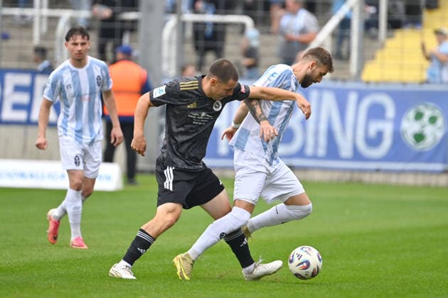 Mirko PUSCHER in action, tackling Eric UHLMANN—1860 Munich, Bavarian Regional League, 2026–2027 season,Matchday 26–27, December 12: TSV 1860 Munich vs. SpVgg Ansbach 4–0 on October 3, 2026, at the Grünwalder Stadion in Munich