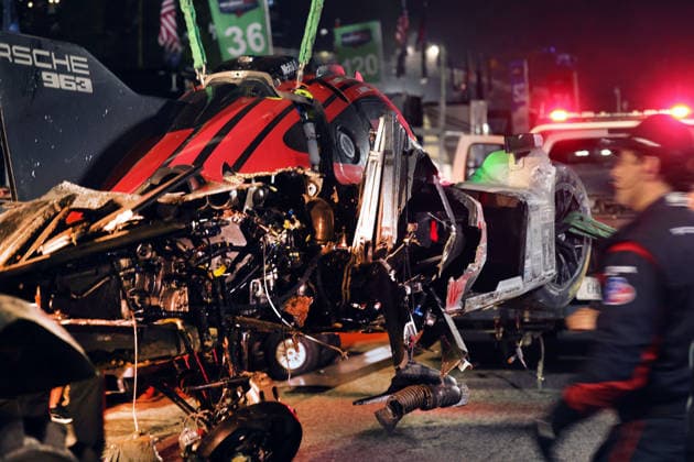 The Porsche 963 No. 7 driven by Felipe Nasr, Laurin Heinrich, and Julien Andlauer—which was severely damaged in an accident—is being unloaded in front of the Porsche Penske tent, IMSA Racing Series, 29th Motul Petit Le Mans race, Road Atlanta, Georgia, USA, October 3, 2026, Retired,