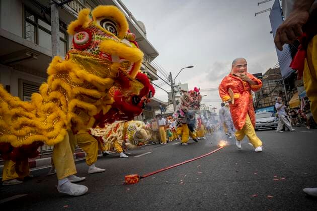 September 25, 2022, Bangkok, Bangkok, Thailand: Traditional Chinese lion dancers jump as fireworks explode in the street on the first day of the Vegetarian Festival. The annual Vegetarian Festival, which derives from Chinese religious influences, began today in cities throughout Thailand. Bangkokâ€⠢s historic Yaowarat Chinatown saw the start of the 11 day long event, with food stalls lining the streets selling vegan food. Bangkok Thailand - ZUMAt128 20220925_zap_t128_010 Copyright: xAdryelxTalamantesx