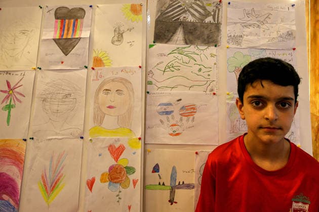 May 5, 2026, Beirut, Beirut, Lebanon: Jawad Qilqas, a displaced boy from the southern Lebanese village of Zifta, sits in front of drawings he did along with other children during a workshop and an exhibition at a local theatre under the slogan Our Land, Our Identity , showcasing childrenâ€⠢s artwork about memory, belonging and hope. Despite an announced ceasefire between Israel and pro-Iranian Hezbollah in place since 17 April, the displacement and humanitarian crisis in Lebanon is far from over. This is a deeply fragile moment, marked by ongoing Israeli airstrikes, shelling, demolitions, evacuation orders, bans on return to certain areas and movement restrictions that continue to drive repeated displacement and rapidly growing huma - ZUMAn313 20260505_zip_n313_010 Copyright: xMarwanxNaamanix