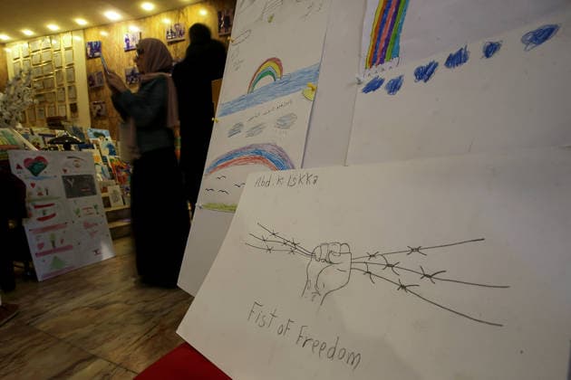 May 5, 2026, Beirut, Beirut, Lebanon: A woman takes pictures of drawings by displaced children during an exhibition at a local theatre under the slogan Our Land, Our Identity , showcasing childrenâ€⠢s artwork about memory, belonging and hope. Despite an announced ceasefire between Israel and pro-Iranian Hezbollah in place since 17 April, the displacement and humanitarian crisis in Lebanon is far from over. This is a deeply fragile moment, marked by ongoing Israeli airstrikes, shelling, demolitions, evacuation orders, bans on return to certain areas and movement restrictions that continue to drive repeated displacement and rapidly growing humanitarian needs. Beirut Lebanon - ZUMAn313 20260505_zip_n313_007 Copyright: xMarwanxNaamanix