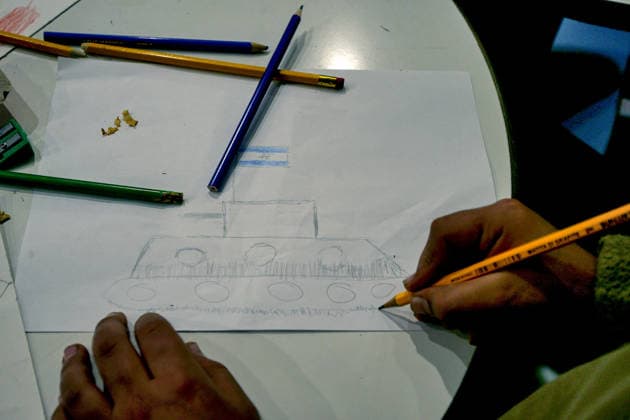 May 5, 2026, Beirut, Beirut, Lebanon: A displaced boy draws and Israeli tank during a workshop and an exhibition for dislocated children at a local theatre under the slogan Our Land, Our Identity , showcasing childrenâ€⠢s artwork about memory, belonging and hope. Despite an announced ceasefire between Israel and pro-Iranian Hezbollah in place since 17 April, the displacement and humanitarian crisis in Lebanon is far from over. This is a deeply fragile moment, marked by ongoing Israeli airstrikes, shelling, demolitions, evacuation orders, bans on return to certain areas and movement restrictions that continue to drive repeated displacement and rapidly growing humanitarian needs. Beirut Lebanon - ZUMAn313 20260505_zip_n313_005 Copyright: xMarwanxNaamanix