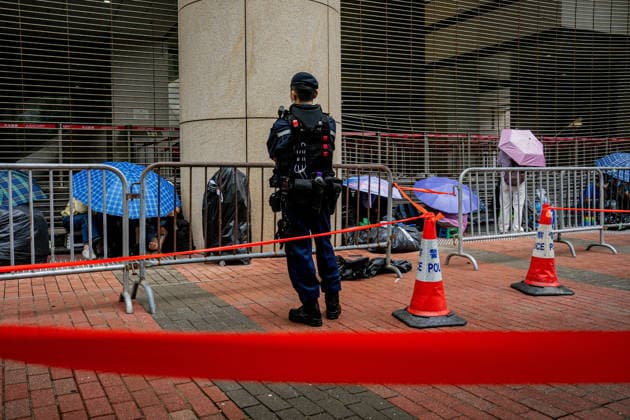 Closing arguments of Tiananmen Square activists trial starts HONG KONG, CHINA - MAY 18: Police officers stand guard outside the West Kowloon Magistrates Court in Hong Kong, China, on May 18, 2026. Closing arguments in the national security case involving the Hong Kong Alliance in Support of Patriotic Democratic Movements of China are scheduled to last three days. Lee Cheuk-yan, 69, and Chow Hang-tung, 41, who organised candlelight vigils to mark Beijing s deadly crackdown on demonstrators in Tiananmen Square in 1989, are standing trial for incitement to subversion , which carries a maximum penalty of 10 years in jail. Harry Leung Anadolu Hong Kong China. Editorial use only. Please get in touch for any other usage. Copyright: x2026xAnadoluxHarryxLeungx