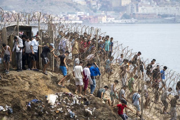 Spain says over 48,300 migrants have returned to Morocco from Ceuta CEUTA, SPAIN - JULY 31: Undocumented migrants, mostly young men, who entered Spain s North African enclave of Ceuta illegally, begin returning to Morocco after realizing their chances of obtaining legal status in Spain are unlikely on July 31, 2026. Meanwhile, small groups of migrants continue trying to cross into Ceuta by swimming or climbing the breakwater surrounding the Fnideq coast. More than 48,300 of the approximately 50,000 migrants who entered the Spanish enclave of Ceuta since early Thursday have returned to Morocco by Friday afternoon, Spain s Interior Ministry said, according to EFE news agency. Abu Adem Muhammed Anadolu Ceuta Spain. Editorial use only. Please Copyright: x2026xAnadoluxAbuxAdemxMuhammedx