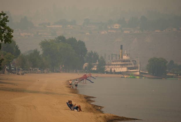 August 9, 2026, Penticton, Bc, CANADA: People sit on the beach as smoke from the Bald Range wildfire envelops Okanagan Lake, in Penticton, B.C., on Sunday, Aug. 9, 2026. The Bald Range wildfire in British Columbia s south Okanagan region has forced 20,000 people out of their homes in the Peachland and Summerland areas. Penticton CANADA - ZUMAc35_ 20260809_zaf_c35_051 Copyright: xDarrylxDyckx