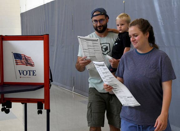 August 11, 2026, Racine, Wisconsin, USA: ALEXANDRIA and TYLER SCHEER, with their son CALLAHAN, 2, vote at Fratt Elementary School in Racine in the Wisconsin primary election Tuesday August 11, 2026. National focus is on the Democratic gubernatorial primary and on efforts to flip several Republican congressional seats, including that of incumbent Bryan Steil who represents the First Congressional District, including Racine County. Racine USA - ZUMAh154 20260811_znp_h154_012 Copyright: xMarkxHertzbergx