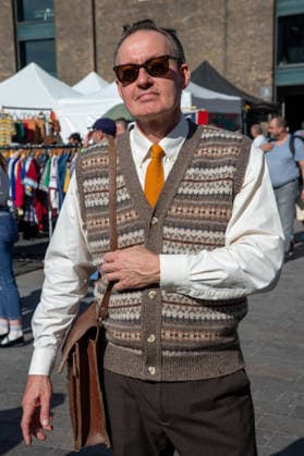 September 26, 2026, London, United Kingdom: An attendee at the King™s Cross Classic Car Boot Sale in London poses for photographs. The Kings Cross Classic Car Boot Sale returned to Granary Square and Stable Street, King™s Cross, London, for its 11th year. Held several times throughout the year, the event brings together vintage fashion, second-hand clothing, jewellery, homewares, collectables and vinyl records alongside classic cars, motorcycles and commercial vehicles. Visitors browsed stalls and traders, with many making a special effort to dress in period clothing inspired by the 1950s, 1960s and 1970s.continuing a tradition associated with the event. London United Kingdom - ZUMAs197 20260926_aaa_s197_390 Copyright: xJamesxWilloughbyx