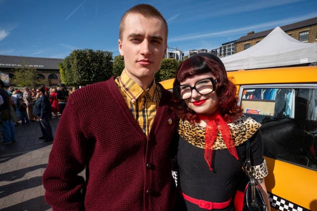September 26, 2026, London, United Kingdom: Two attendees at the King™s Cross Classic Car Boot Sale dressed in vintage clothing. The Kings Cross Classic Car Boot Sale returned to Granary Square and Stable Street, King™s Cross, London, for its 11th year. Held several times throughout the year, the event brings together vintage fashion, second-hand clothing, jewellery, homewares, collectables and vinyl records alongside classic cars, motorcycles and commercial vehicles. Visitors browsed stalls and traders, with many making a special effort to dress in period clothing inspired by the 1950s, 1960s and 1970s.continuing a tradition associated with the event. London United Kingdom - ZUMAs197 20260926_aaa_s197_373 Copyright: xJamesxWilloughbyx