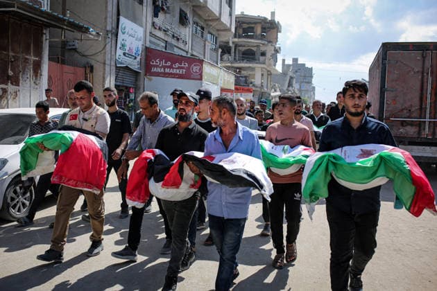 Palestinians Hold Mass Funeral for 105 Recovered from Gaza Rubble Palestinians take part in a mass funeral for 105 Palestinians whose remains were recovered from beneath the rubble of destroyed buildings in the al-Taj area of Gaza City’s al-Yarmouk neighborhood on October 1, 2026. The victims, including women and children, were killed in Israeli airstrikes during the early stages of the war, with families gathering for their funeral and burial after their remains had been trapped under the rubble for years. Photo by Mohammed Salha apaimages Gaza Gaza Strip Palestinian Territory 011026_Gaza_MS_00(11) Copyright: xapaimagesxMohammedxSalhax xapaimagesx