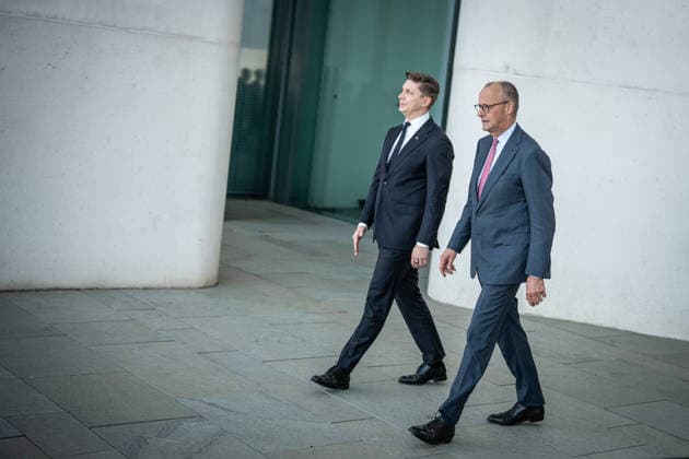 Chancellor Friedrich Merz with his guest Mindaugas Sinkeviciusius, Prime Minister of Lithuania, at the Federal Chancellery; on the terrace of the Federal Chancellery overlooking the Reichstag building, which houses the Bundestag; the Federal Chancellor receives the Prime Minister of the Republic of Lithuania at the Federal Chancellery, Berlin, Germany; Federal Chancellery