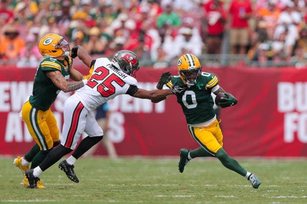 Oct 4, 2026; Tampa, FL, USA; Green Bay Packers wide receiver Matthew Golden (0) attempts to avoid a tackle by Tampa Bay Buccaneers cornerback Jacob Parrish (25) during the NFL, American Football Herren, USA game between the Green Bay Packers and Tampa Bay Buccaneers at Raymond James Stadium. Mandatory Credit: Taylor McFee-Cal Media NFL 2026: Packers Vs Buccaneers OCT 04 - ZUMAc04_ 20261004_zma_c04_622 Copyright: xTaylorxMcfeex