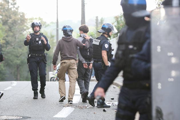 October 5, 2026, Anglet, Nouvelle Aquitaine, France: Police officers from the anti-crime brigade (BAC) detain a handcuffed youth who had been hiding in bushes during a protest by high school students against the government outside the Cantau high school in Anglet, southwestern France, on October 5, 2026. Students have been blocking schools across France since September 21 to demand more teachers, smaller classes and better school buildings. Cantau was closed by authorities after clashes in recent days. Anglet France - ZUMAb298 20261005_zsp_b298_020 Copyright: xJulesxBuonx