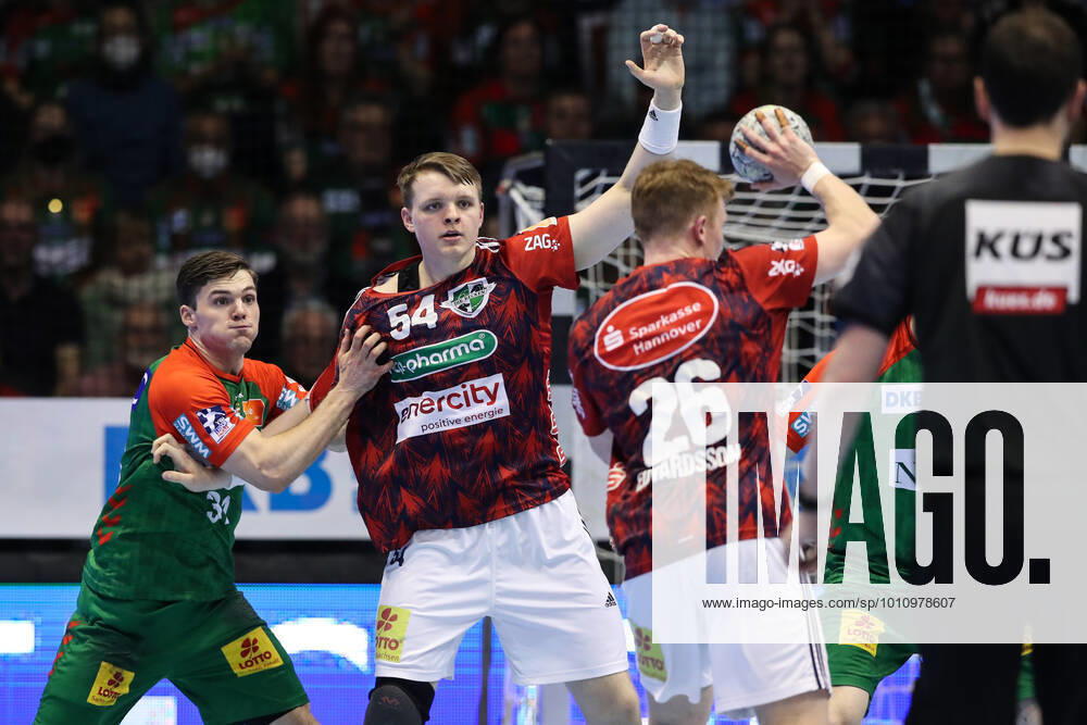 Justus Fischer TSV Hannover Burgdorf,54 and Jonathan Edvardsson TSV Hannover Burgdorf,26 against Kay Smits SC Magdeburg,31 Handball Bundesliga season 2021 2022 SC Magdeburg vs TSV Hannover Burgdorf at GETEC Arena in Magdeburg Action,man,men,handball,Germany