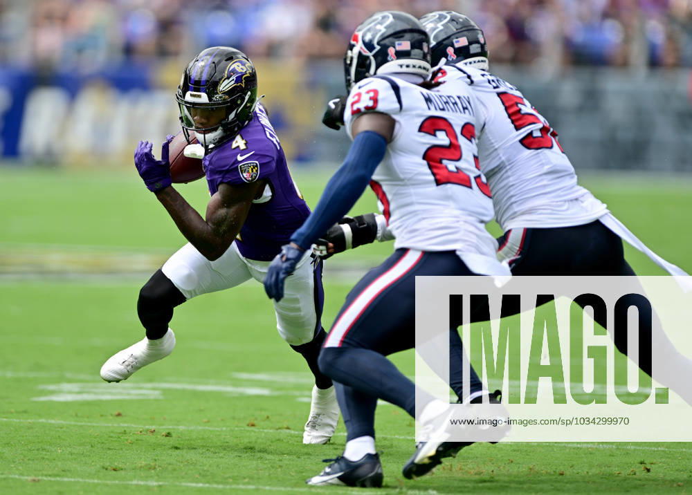 Baltimore Ravens wide receiver Zay Flowers (4) runs for short yardage against Houston Texans safety Eric Murray (23) and defensive end Jonathan Greenard (R) during the first half of the Baltimore Ravens home opener at M&T Bank Stadium in Baltimore, Maryland, on Sunday, September 10, 2023. BAL20230910133 DAVIDxTULIS