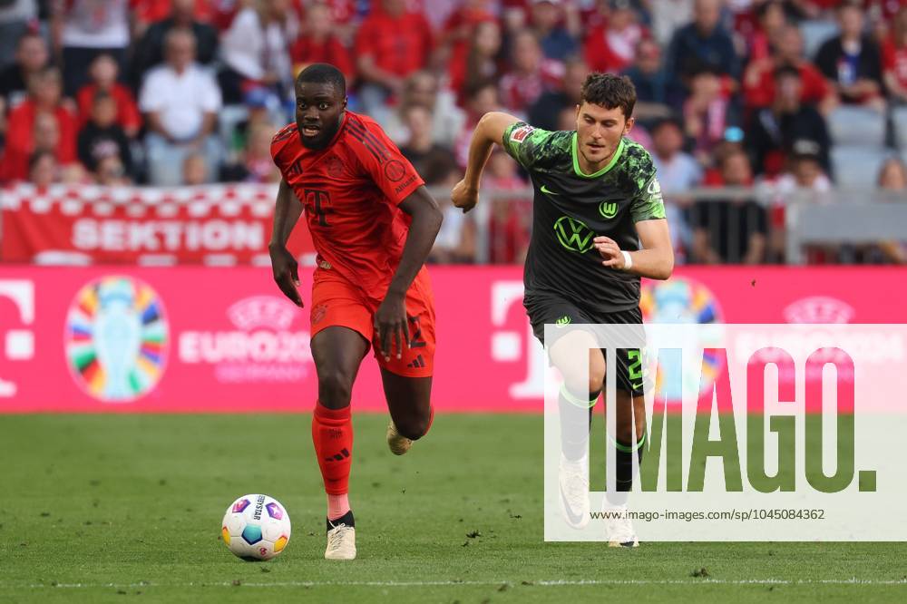 In duel, action, with Dayot Upamecano 2 FC Bayern Muenchen , Jonas Wind 23 VfL Wolfsburg , FC Bayern Muenchen vs VfL Wolfsburg, Football, 1 Bundesliga, 33 Matchday, 12 05 2024 DFB regulations prohibit any use of photographs as image sequences and or quasi video Muenchen Bayern Germany