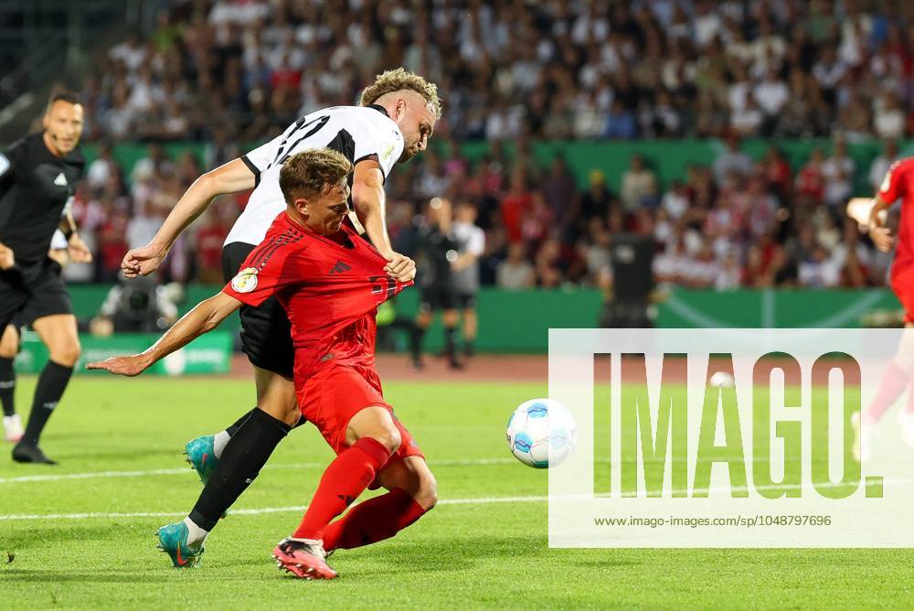 In duel, action, with Joshua Kimmich 6 FC Bayern Muenchen , Philipp Strompf 32 SSV Ulm 1846 , SSV Ulm 1846 vs FC Bayern Muenchen, Football, DFB Pokal, 1 Runde, 16 08 2024 DFB regulations prohibit any use of photographs as image sequences and or quasi video Ulm Baden Wuerttemberg Germany