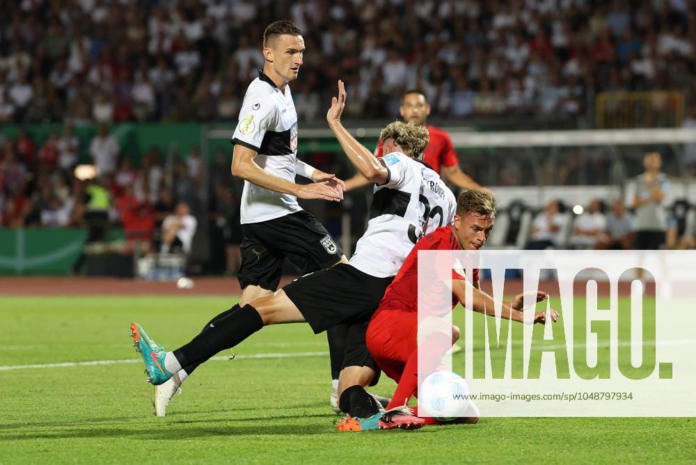 In duel, action, with Joshua Kimmich 6 FC Bayern Muenchen , Philipp Strompf 32 SSV Ulm 1846 , SSV Ulm 1846 vs FC Bayern Muenchen, Football, DFB Pokal, 1 Runde, 16 08 2024 DFB regulations prohibit any use of photographs as image sequences and or quasi video Ulm Baden Wuerttemberg Germany