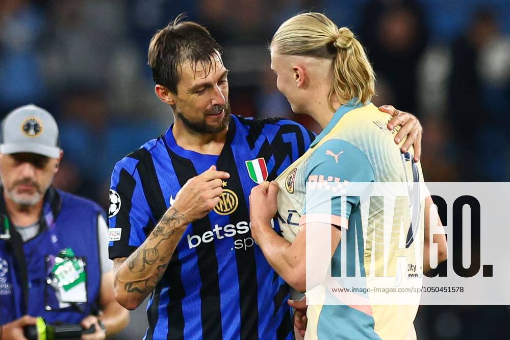 Erling Haaland of Manchester City and Francesco Acerbi of Inter Milan point to their shirts at full-time to suggest a swap Manchester City v Inter Milan, UEFA Champions League, Group Stage, Football, Etihad Stadium, Manchester, UK, 18 Sep 2024