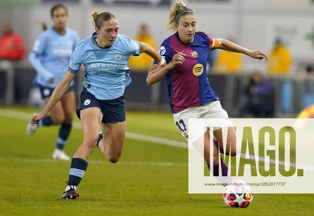Manchester, England, 9th October 2024. Alexia Putellas of Barcelona (R) is challenged by Naomi Layzell of Manchester City during the UEFA Womens Champions League match at the Academy Stadium, Manchester. Picture credit should read: Andrew Yates Sportimage . SPI-3368-0005