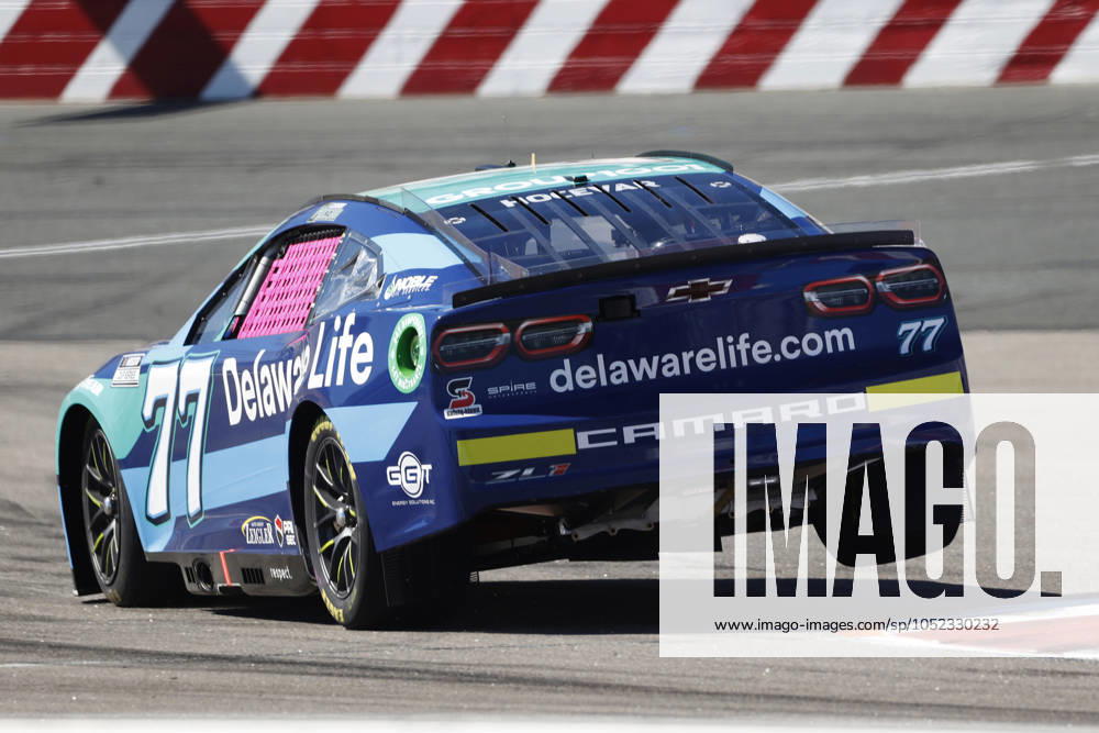 CHARLOTTE, NC - OCTOBER 12: Carson Hocevar ( 77 Spire Motorsports Delaware Life Chevrolet) drives over the rumble strips in turn 16 during qualifying for the NASCAR, Motorsport, USA Cup Series Bank of America ROVAL 400 on October 12, 2024 at Charlotte Motor Speedway in Charlotte, NC. (Photo by Jeff Robinson Icon Sportswire) AUTO: OCT 12 NASCAR Cup Series Bank of America ROVAL 400 Icon2410122985400