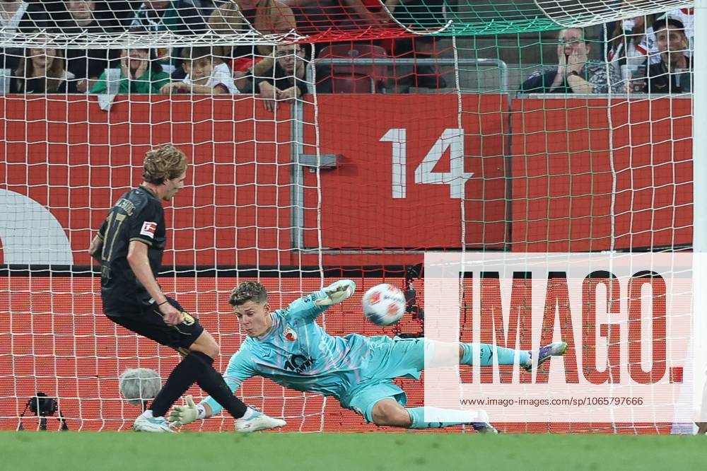 Goalkeeper action by Finn Dahmen 1 FC Augsburg , FC Augsburg vs FC Bayern Muenchen, Soccer, 1 Bundesliga, 2 Matchday, 30 08 2025 DFB regulations prohibit any use of photographs as image sequences and or quasi video Augsburg Bayern Germany