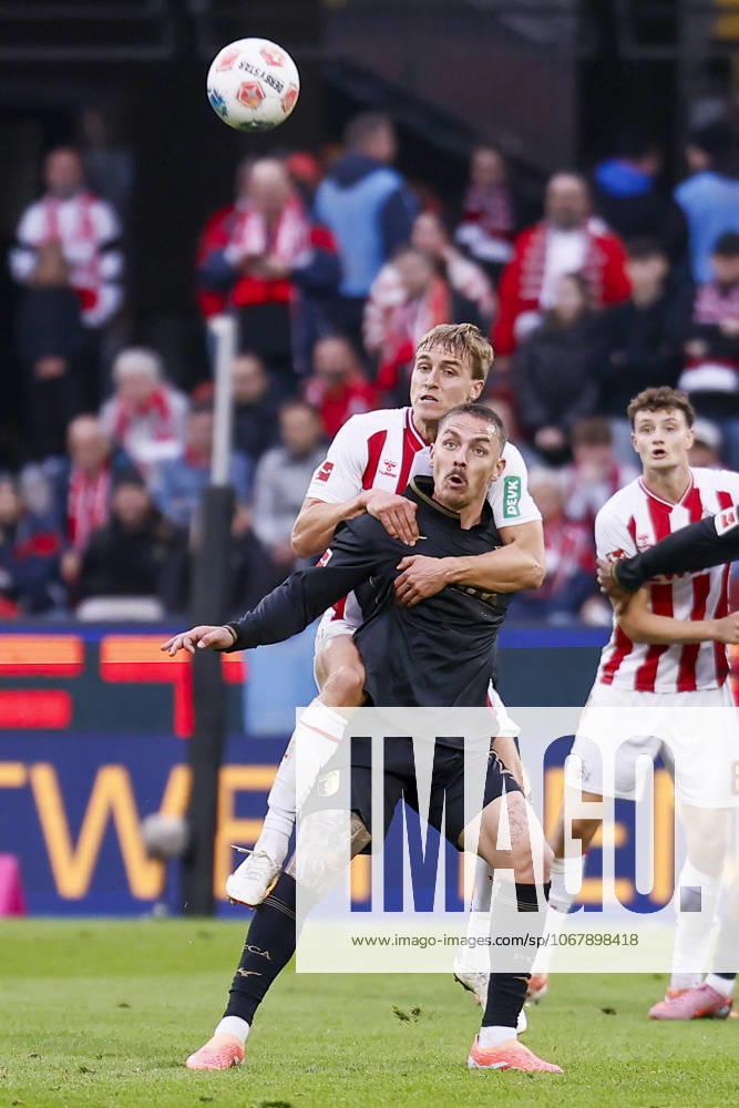 Timo Huebers (Hubers Hübers 1. FC Koeln, 4), Phillip Tietz (FC Augsburg, 21) during the Bundesliga match between 1. FC Koeln vs. FC Augsburg at the Rheinenergie-Stadion on matchday 7 of the 1. Bundesliga on October 18, 2025 in Koeln, Germany. DFL REGULATIONS PROHIBIT ANY USE OF PHOTOGRAPHS AS IMAGE SEQUENCES AND OR QUASI-VIDEO. Nordrhein-Westfalen Germany