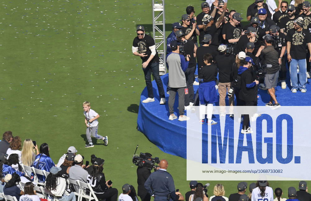 Los Angeles Dodgers first baseman Freddie Freeman (L) keeps an eye on his son Maximus as he celebrates their World Series win with teammates following a parade at Dodger Stadium in Los Angeles on Monday, November 3, 2025. LAP2025110316 JIMxRUYMEN