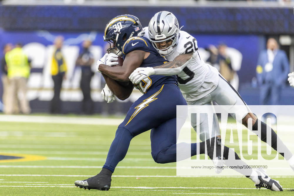 NFL, American Football Herren, USA 2025: Los Angeles Chargers 31:14 Las Vegas Raiders Los Angeles Chargers running back Kimani Vidal 30 is tackled by Las Vegas Raiders safety Isaiah Pola-Mao 20 during an NFL football game at SoFi Stadium, Sunday Nov. 30, 2025, in Inglewood, Calif. Los Angeles United States