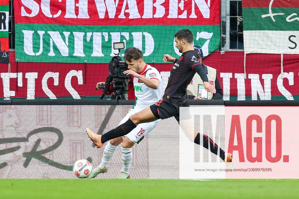 In duel, action, with Robin Fellhauer 19 FC Augsburg , Martin Terrier 11 Bayer 04 Leverkusen , FC Augsburg vs Bayer 04 Leverkusen, Football, 1 Bundesliga, 13 Matchday, 06 12 2025 DFB regulations prohibit any use of photographs as image sequences and or quasi video Augsburg Bayern Germany