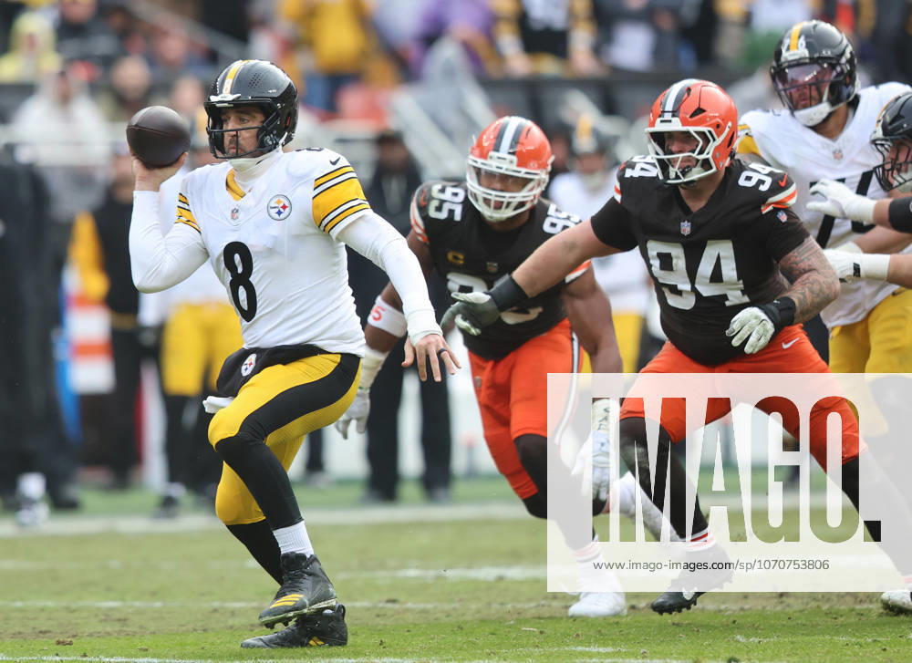 Pittsburgh Steelers quarterback Aaron Rogers (8) fakes a pass as he scrambles away from Cleveland Browns Myles Garrett (95) and Mason Graham (94) during the second quarter at Huntington Bank Field in Cleveland, Ohio on Sunday December 28, 2025. CLE20251228111 AARONxJOSEFCZYK