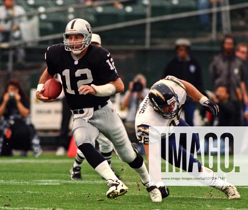 Oakland, California, U.S - Oakland Raiders vs. San Diego Chargers at Oakland Alameda County Coliseum Sunday, November 14, 1999. Raiders beat Chargers 28-9. San Diego Chargers defensive tackle Mike Mohring (98) and Oakland Raiders quarterback Rich Gannon