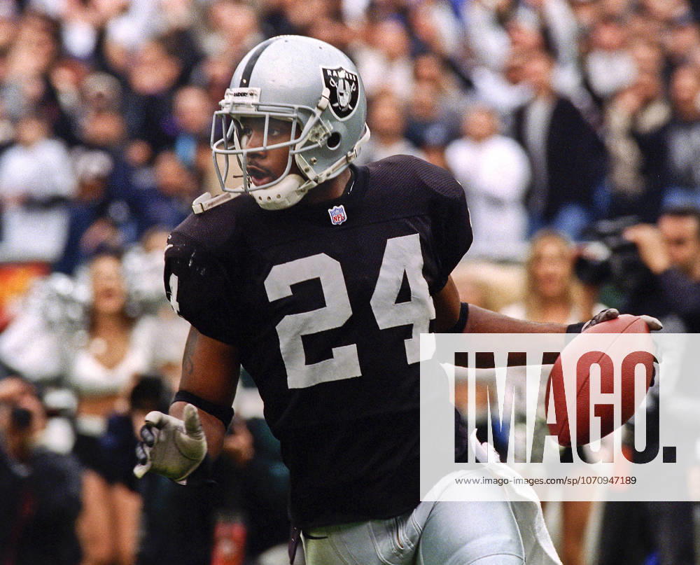 Oakland, California, U.S - Oakland Raiders vs. Kansas City Chiefs at Oakland Alameda County Coliseum Sunday, November 29, 1999. Chiefs beat Raiders 37-34. Oakland Raiders defensive back Charles Woodson (24) recovers ball.