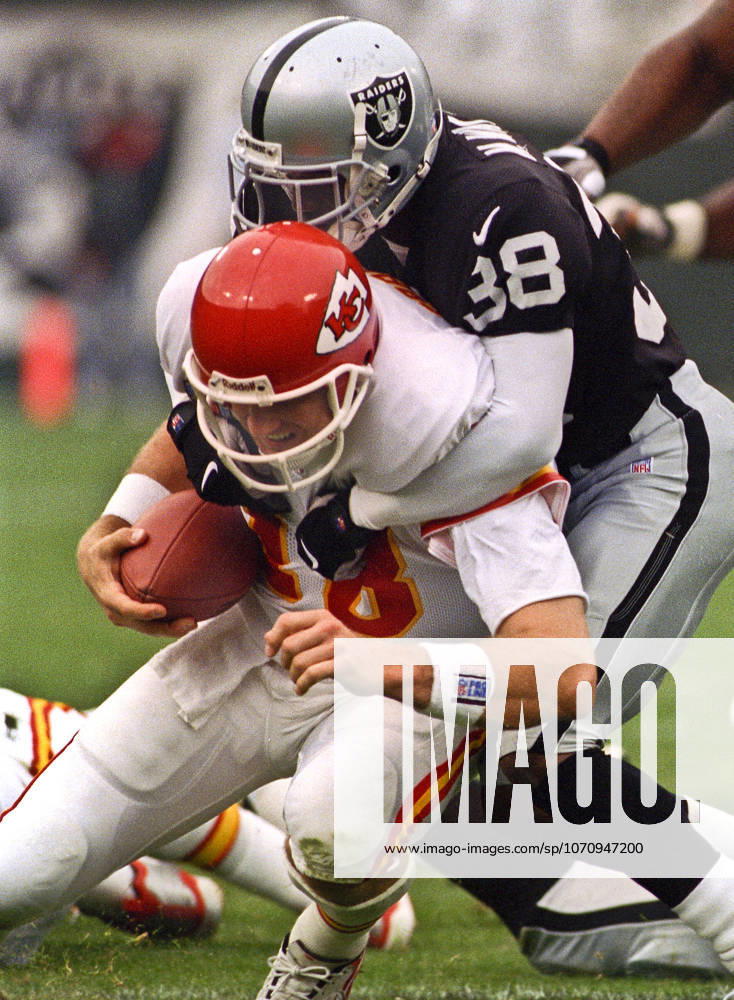 Oakland, California, U.S - Oakland Raiders vs. Kansas City Chiefs at Oakland Alameda County Coliseum Sunday, November 29, 1999. Chiefs beat Raiders 37-34. Oakland Raiders defensive back Marquis Walker (38) sacks Kansas City Chiefs quarterback Elvis Grbac