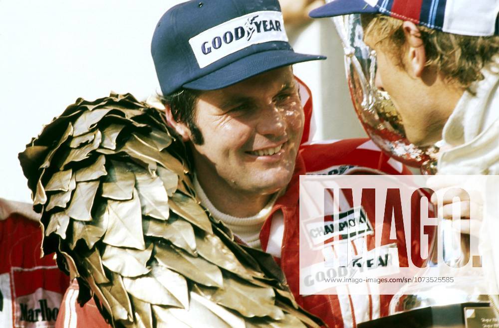 L to R): Alan Jones (AUS) Shadow, who claimed his first GP victory and the only GP win for the Shadow team, celebrates on the podium with Hans-Joachim Stuck (GER) Brabham, who finished in third position...Austrian Grand Prix, Rd 12, Osterreichring, Austria, 14 August 1977...BEST IMAGE.