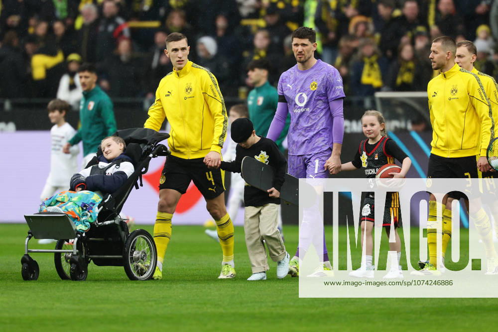Dortmund, Germany, 14 03 26, Nico Schlotterbeck Borussia Dortmund , Gregor Kobel Borussia Dortmund and Waldemar Anton Borussia Dortmund with a child during the Bundesliga 1 match between Borussia Dortmund FC Augsburg at Signal Iduna Park in Dortmund Photo by Joachim Bywaletz DFB DFL REGULATIONS PROHIBIT ANY USE OF PHOTOGRAPHS AS IMAGE SEQUENCES AND OR QUASI VIDEO
