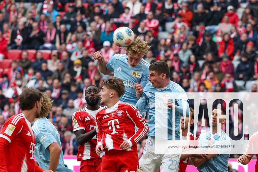 In duel, action, with Dayot Upamecano 2 FC Bayern Muenchen , Lennart Karl 42 FC Bayern Muenchen , Leopold Querfeld 14 1 FC Union Berlin , Andrej Ilic 23 1 FC Union Berlin , FC Bayern Muenchen vs 1 FC Union Berlin, Football, 1 Bundesliga, 27 Matchday, 21 03 2026 DFB regulations prohibit any use of photographs as image sequences and or quasi video Muenchen Bayern Germany