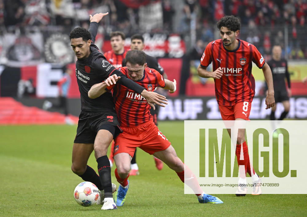One-on-one, action Budu Zivzivadze Siwsiwadse 1 FC Heidenheim 1846 FCH 11 vs Jarell Quansah Bayer 04 Leverkusen 04 Eren Dinkci 1 FC Heidenheim 1846 FCH 08 1 FC Heidenheim 1846 FCH vs Bayer 04 Leverkusen B04 21 03 2026 DFL REGULATIONS PROHIBIT ANY USE OF PHOTOGRAPHS AS IMAGE SEQUENCES AND OR QUASI VIDEO 1 FC Heidenheim 1846 FCH vs Bayer 04 Leverkusen