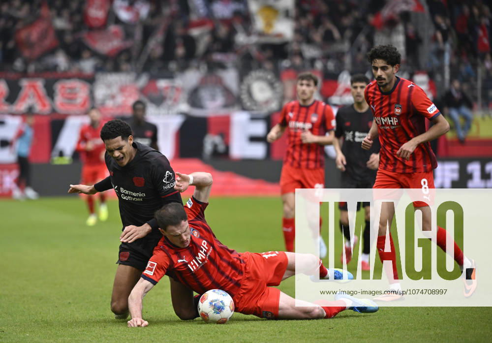 One-on-one, action Budu Zivzivadze Siwsiwadse 1 FC Heidenheim 1846 FCH 11 vs Jarell Quansah Bayer 04 Leverkusen 04 Eren Dinkci 1 FC Heidenheim 1846 FCH 08 1 FC Heidenheim 1846 FCH vs Bayer 04 Leverkusen B04 21 03 2026 DFL REGULATIONS PROHIBIT ANY USE OF PHOTOGRAPHS AS IMAGE SEQUENCES AND OR QUASI VIDEO 1 FC Heidenheim 1846 FCH vs Bayer 04 Leverkusen