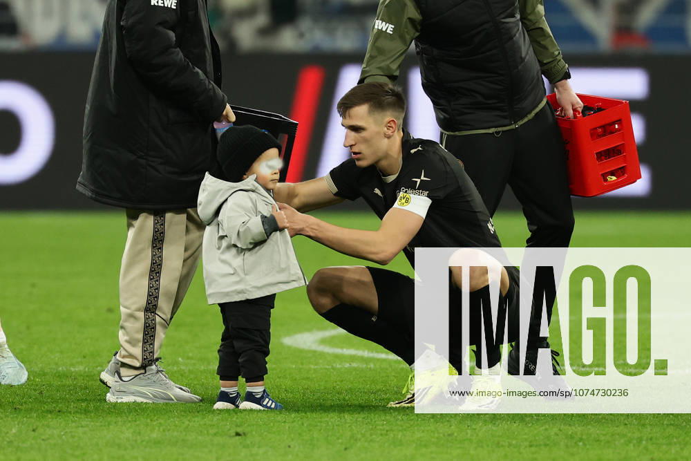 Dortmund, Germany, 21 03 26, Nico Schlotterbeck Borussia Dortmund and a child during the Bundesliga 1 match between Borussia Dortmund Hamburger SV at Signal Iduna Park in Dortmund Photo by Joachim Bywaletz DFB DFL REGULATIONS PROHIBIT ANY USE OF PHOTOGRAPHS AS IMAGE SEQUENCES AND OR QUASI VIDEO