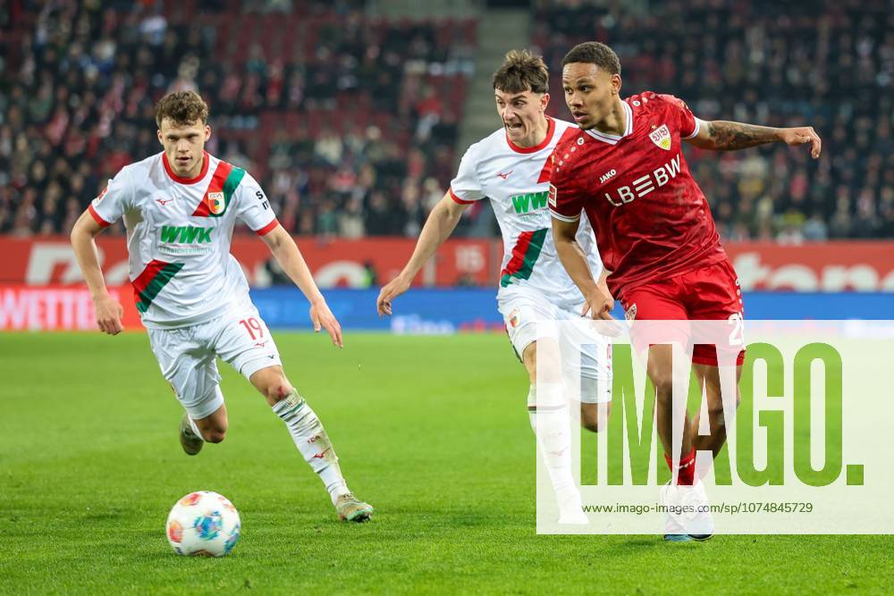 In duel, action, with Robin Fellhauer 19 FC Augsburg , Cedric Zesiger 16 FC Augsbburg , Nikolas Nartey 28 VfB Stuttgart , FC Augsburg vs VfB Stuttgart, Football, 1 Bundesliga, 27 Matchday, 22 03 2026 DFB regulations prohibit any use of photographs as image sequences and or quasi video Augsburg Bayern Germany