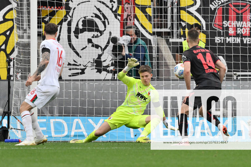Goalkeeper Finn Dahmen FC Augsburg in action, right Patrik Schick Bayer 04 Leverkusen 18 04 2026, Soccer 1 Bundesliga, Season 2025 2026, 30 Matchday, Bayer 04 Leverkusen FC Augsburg 1 2 DFL regulations prohibit any use of photographs as image sequences and or quasi video Leverkusen BayArena Nordrhein Westfalen Germany Team2