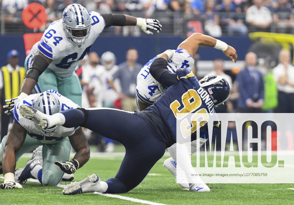 Dallas Cowboys quarterback Dak Prescott 4 escapes what would be a sack in the second quarter by Los Angeles Rams defensive tackle Caushaud Lyons 99 during an NFL, American Football Herren, USA football game between the Los Angeles Rams and the Dallas Cowboys at AT&T Stadium in Arlington, TX Dallas leads at the half 24-16 Albert Pena CSM