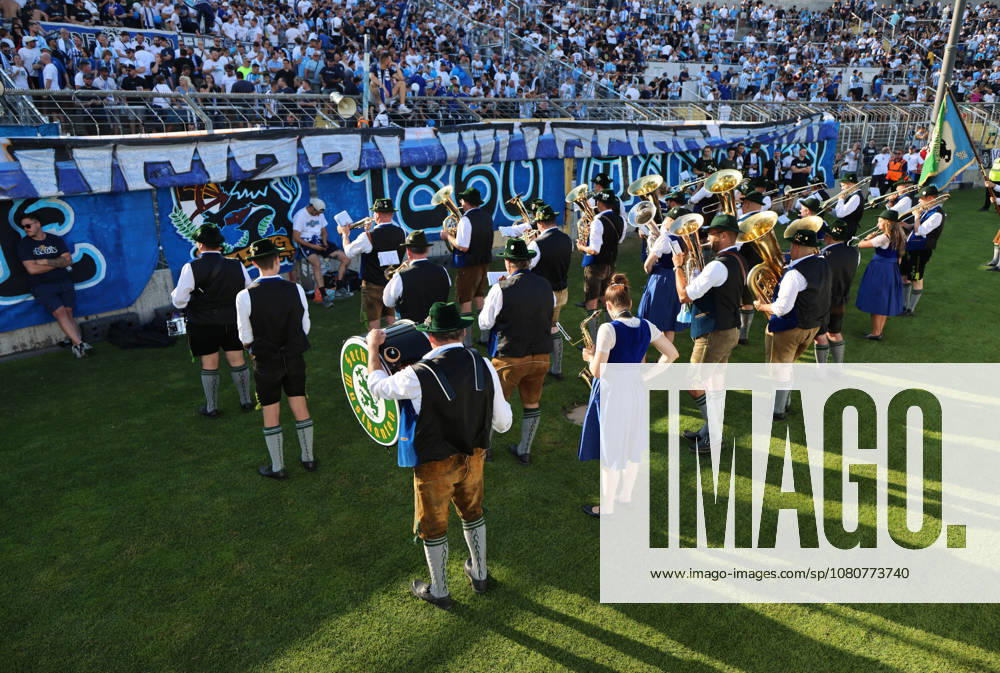 Soccer, Men s, Bavarian Regional League, 2026–2027 Season, TSV 1860 Munich vs. FC Augsburg II, Grünwalder Stadium: The Sechzger Musikanten, a brass band affiliated with TSV 1860 Munich, performing in front of the West Stand
