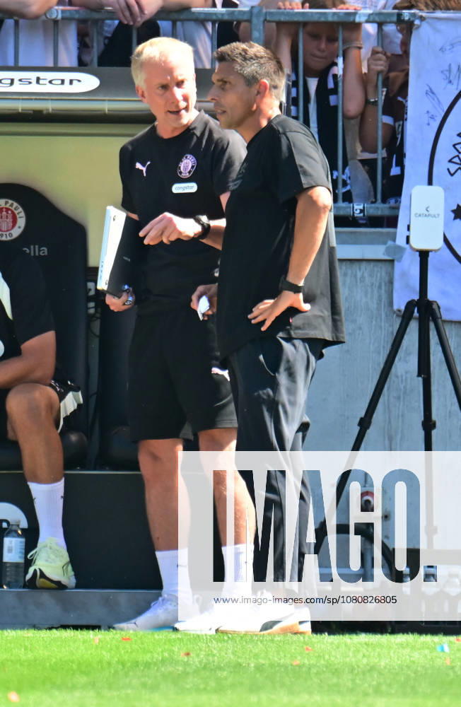 GER Soccer, Men, 2nd Division, Matchday 1, 2026–2027 Season, Hamburg, FC St. Pauli vs. SpVgg Greuther Fürth Coach Marcel Rapp of St. Pauli talks with assistant coach Jens Schuster. St. Pauli. DFB and DFL regulations prohibit any use of photographs as image sequences and or quasi-video. Hamburg, Millerntorstadion, Hamburg, Germany