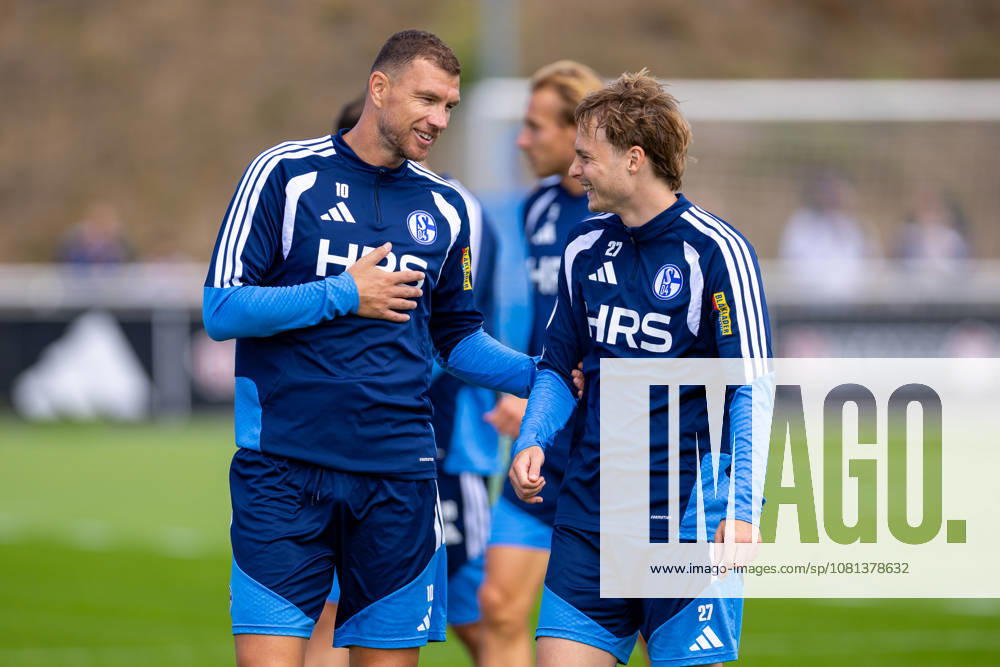 Soccer, FC Schalke 04 training session featuring Edin Dzeko (FC Schalke 04) and Finn Porath (FC Schalke 04) laughing at the FC Schalke 04 training facility in Gelsenkirchen, North Rhine-Westphalia, Germany xRHR PHOTO YYx